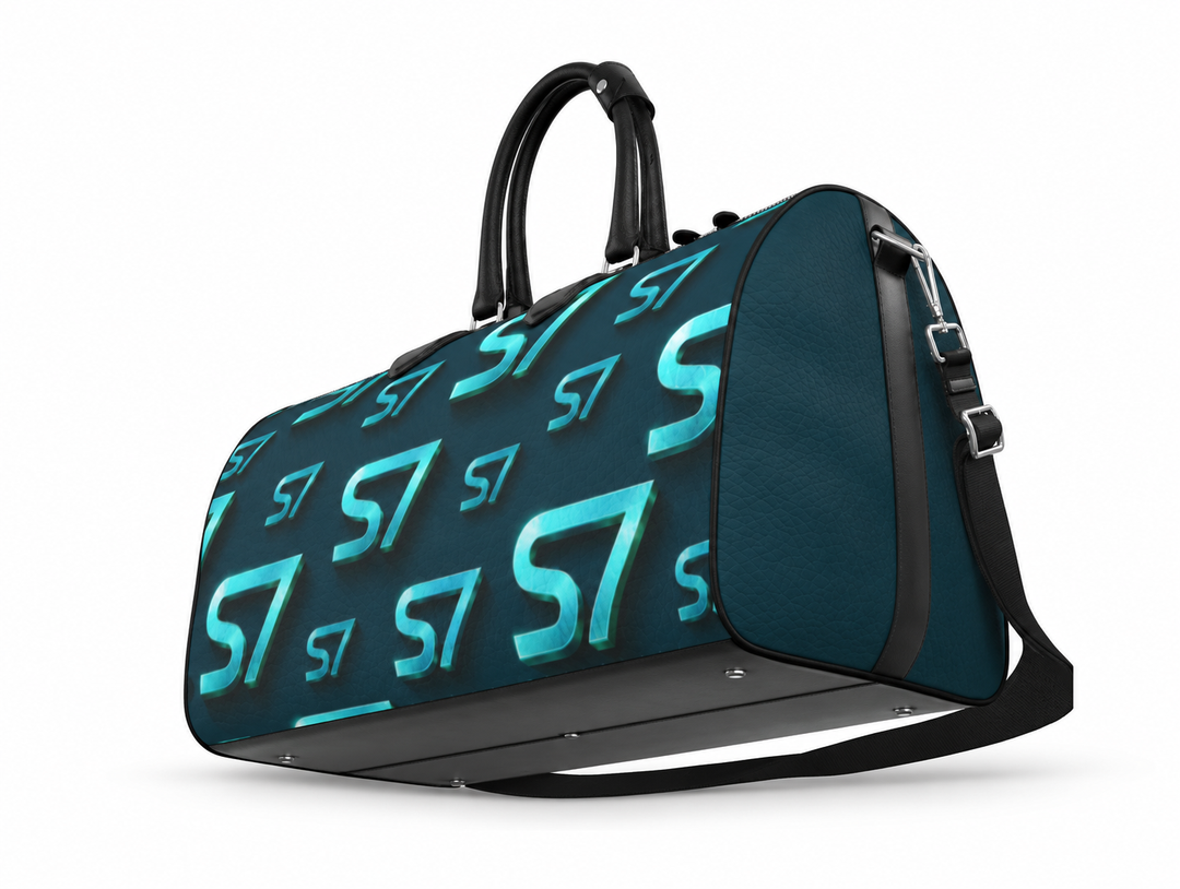S7 Electric Lagoon bag featuring dimensional turquoise monograms, midnight teal side panels, and nickel-tone hardware.