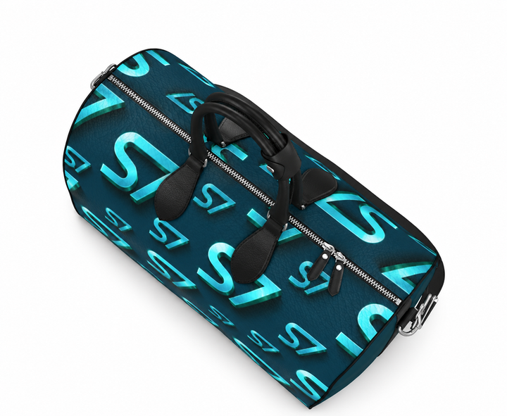 S7 Electric Lagoon bag featuring dimensional turquoise monograms, midnight teal side panels, and nickel-tone hardware.