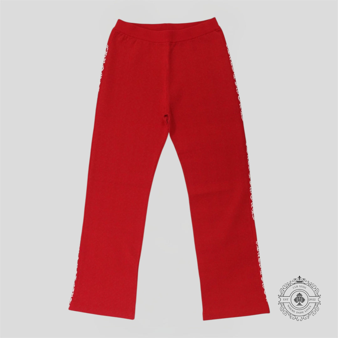 Red pants with frayed edges on a gray background