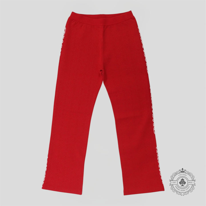Red pants with frayed edges on a gray background