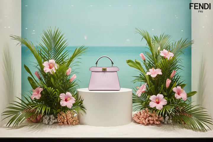 Pink handbag with gold clasp on a white background