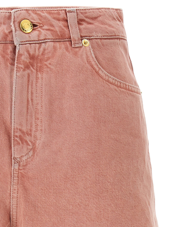 Close-up of a pink denim skirt with gold buttons on a white background