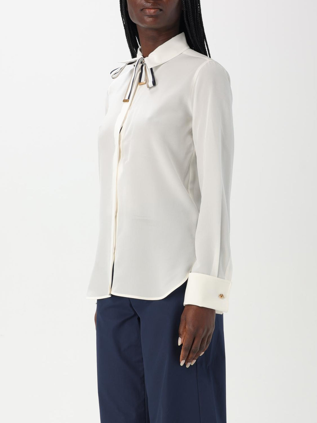 White blouse with a bow tie worn by a person on a white background