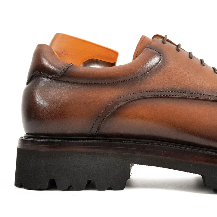 Side view of Handmade Goodyear Welted Derby Shoes by DV DIVINCH, rich brown calfskin, lug sole detail.