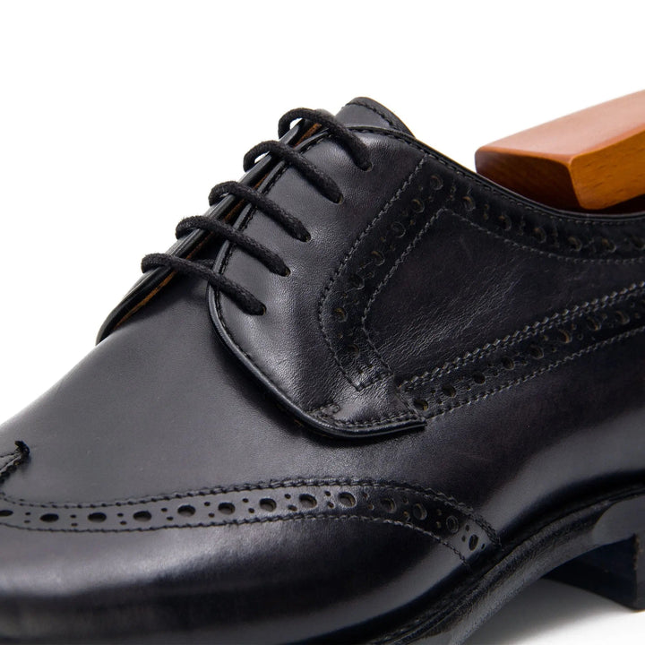 Goodyear Welt Brogue Shoes in black calfskin leather, detailed view showing U-wing design and brogue perforations.