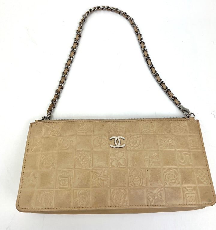Beige handbag with chain strap and Chanel logo on a white background