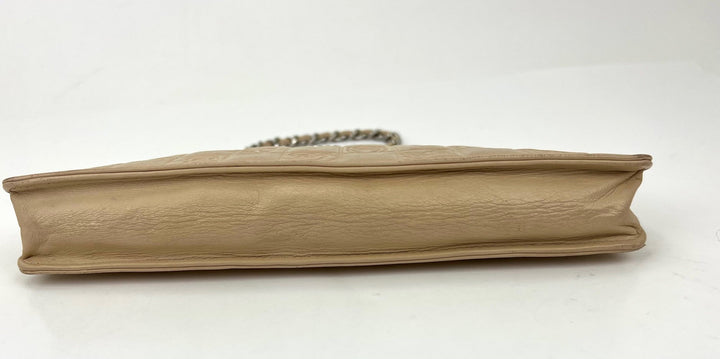 Beige clutch bag on a white background