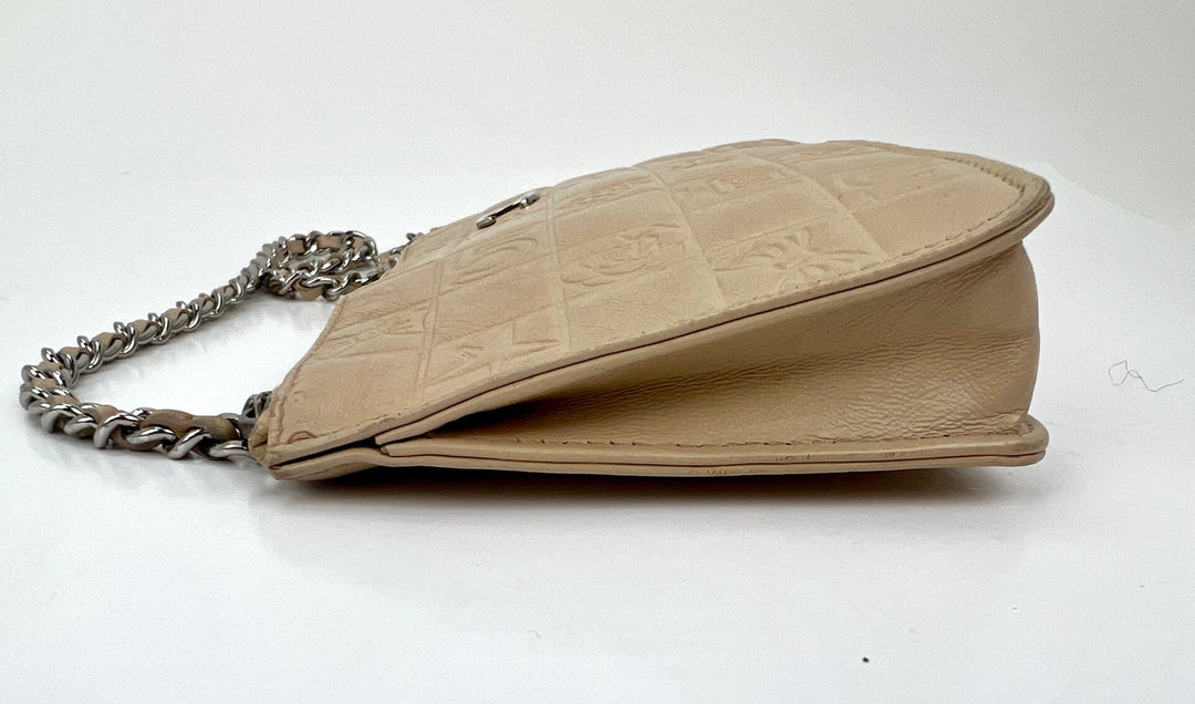 Beige handbag with chain strap on a white background