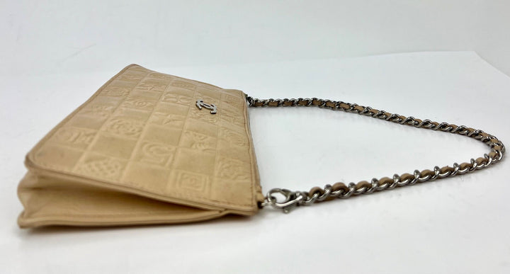 Beige handbag with chain strap on a white background