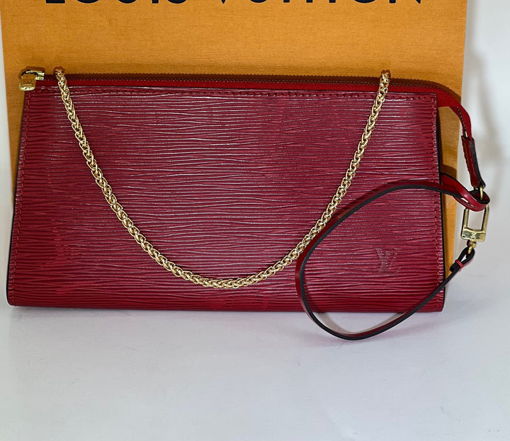 Red handbag with gold chain strap on a white background