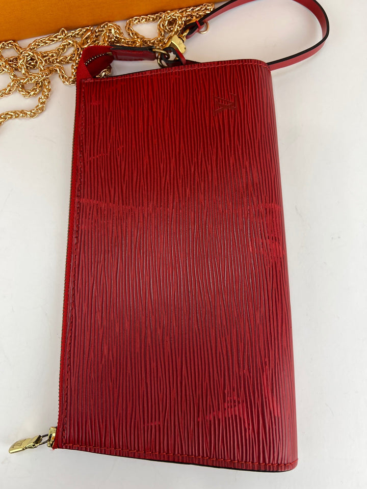 Red textured handbag with gold chain on a white background