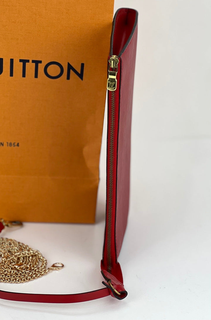 Red handbag with gold chain and Louis Vuitton box in the background