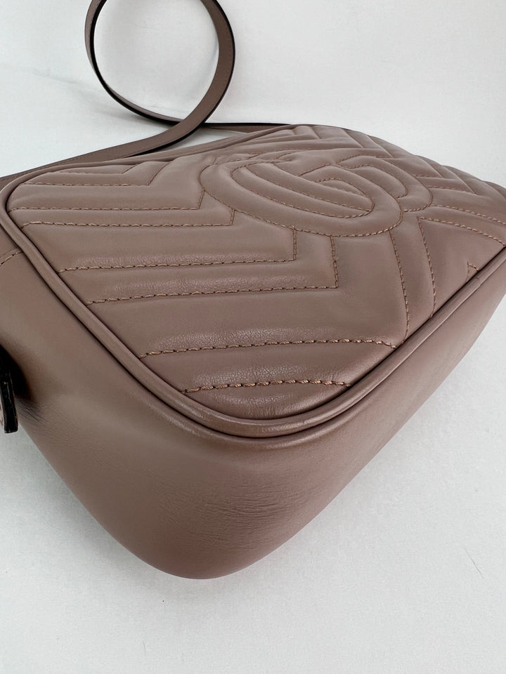 Brown quilted handbag on a white background