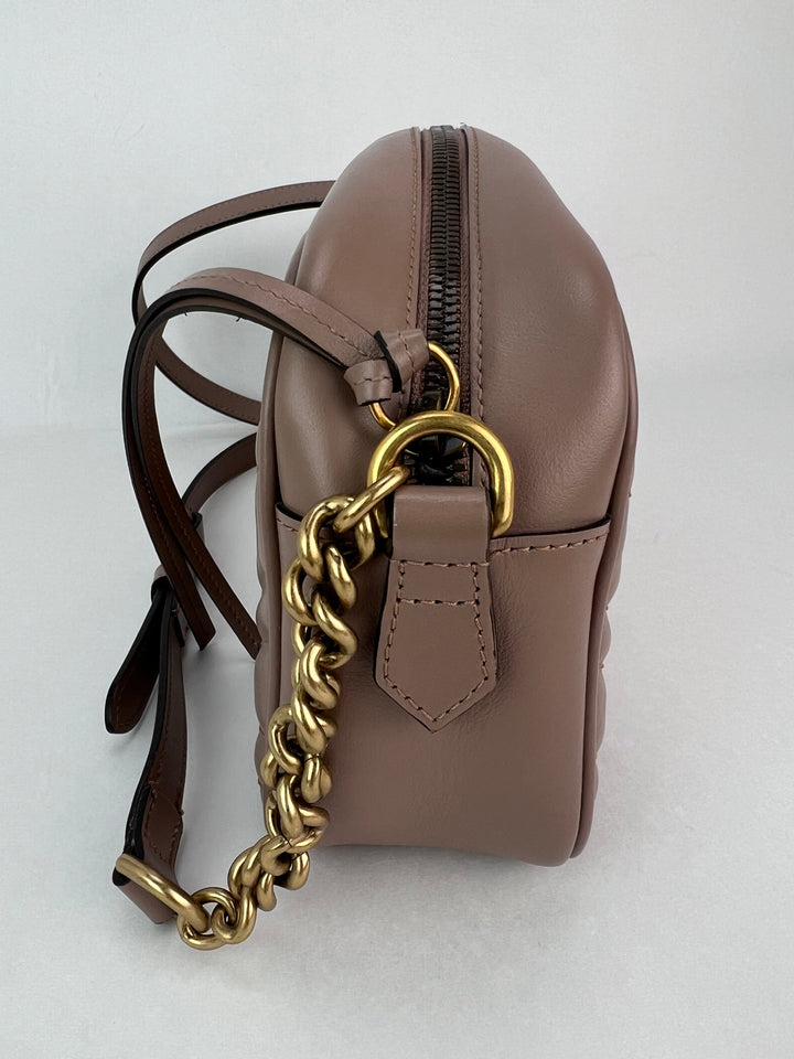Brown leather backpack with a gold chain on a white background