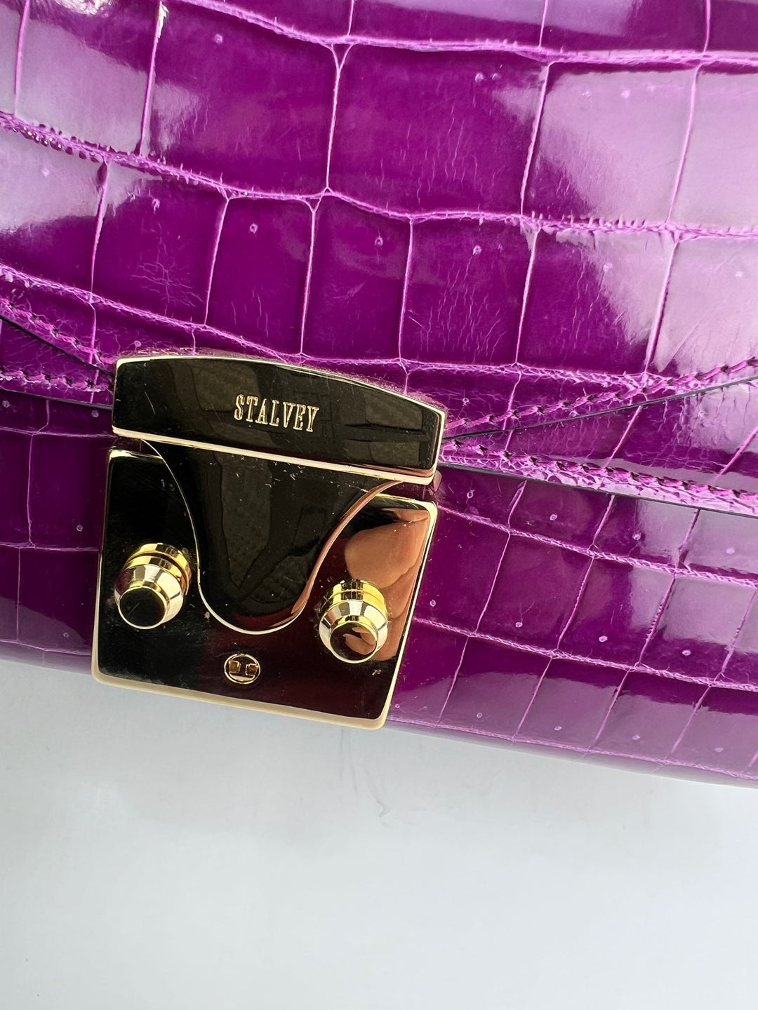 Close-up of the lock closure on the Exclusive Stalvey Top Handle 2.0 Alligator Bag Crossbody Luxury Bag.