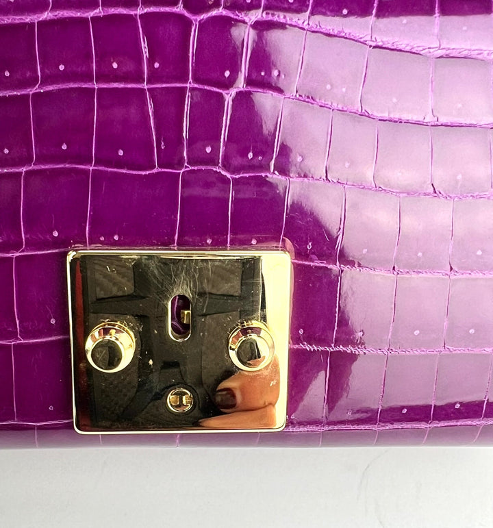 Close-up of the gold lock closure on the Exclusive Stalvey Top Handle 2.0 Alligator Bag Crossbody Luxury Bag.