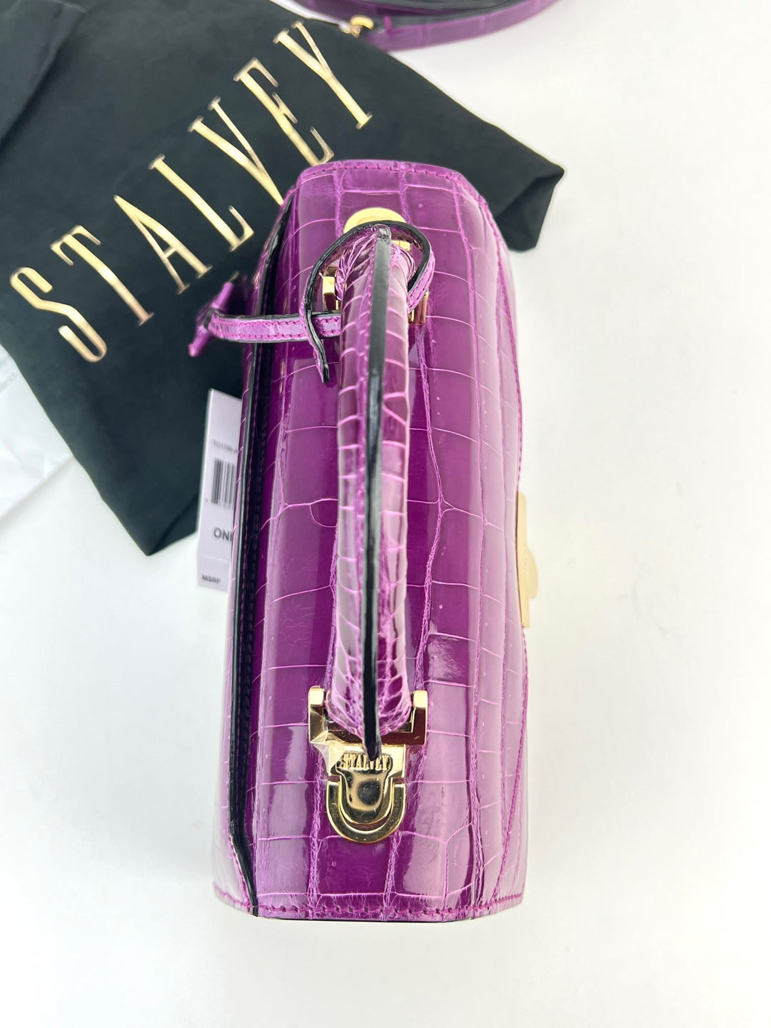 Exclusive Stalvey Top Handle 2.0 Alligator Bag Crossbody Luxury Bag in vibrant purple with logo-engraved lock closure.
