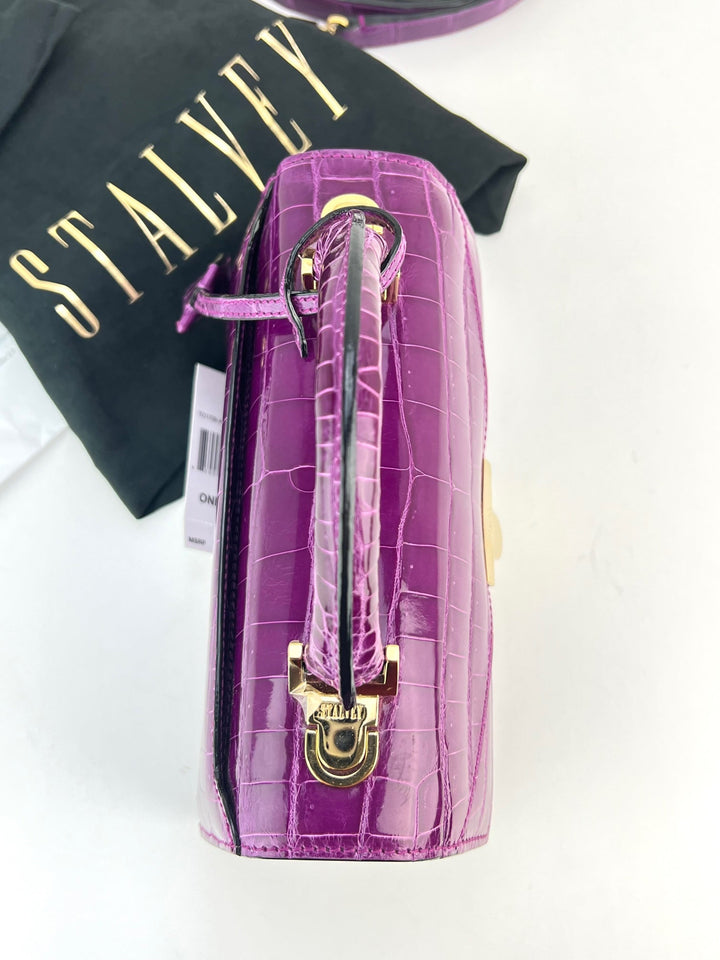 Exclusive Stalvey Top Handle 2.0 Alligator Bag Crossbody Luxury Bag in vibrant purple with logo-engraved lock closure.