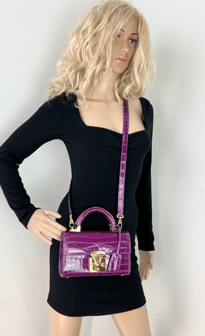 Exclusive Stalvey Top Handle 2.0 Alligator Bag Crossbody Luxury Bag in vibrant purple, showcased on a mannequin.