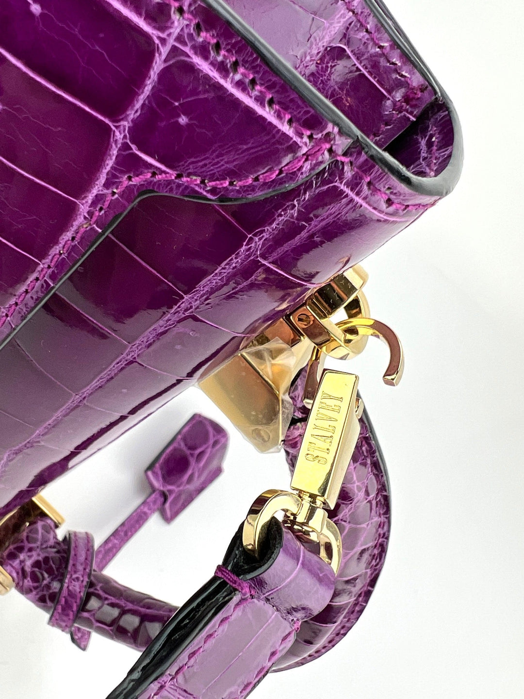 Exclusive Stalvey Top Handle 2.0 Alligator Bag Crossbody Luxury Bag in vibrant purple with gold hardware detail.