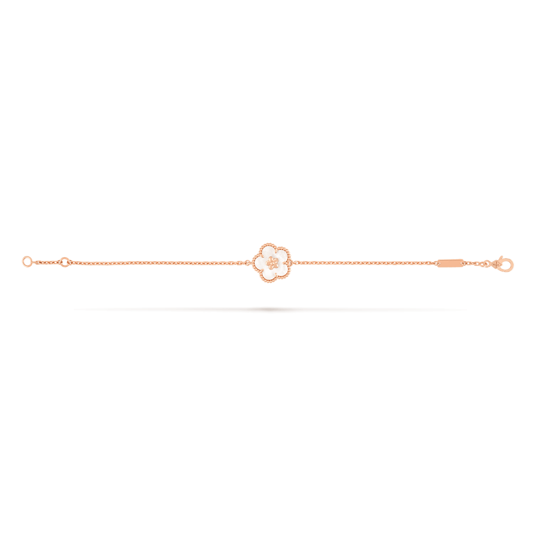 Van Cleef & Arpels Lucky Spring bracelet, plum blossom 18K rose gold, Mother-of-pearl on display.