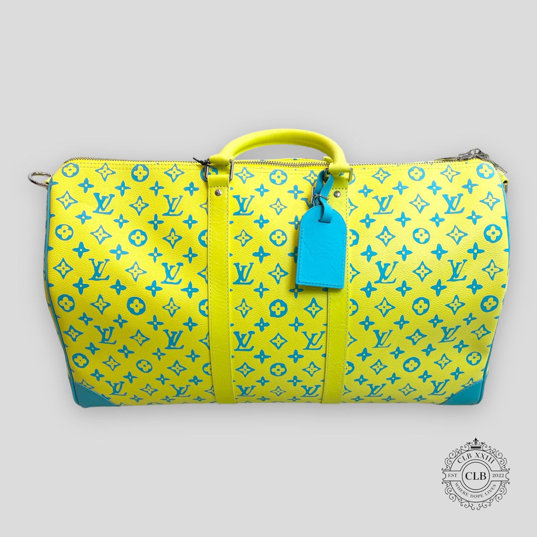 Yellow and blue patterned suitcase with a blue tag on a light gray background