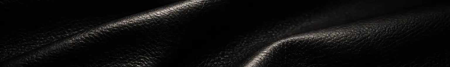 Close-up of black leather texture with folds