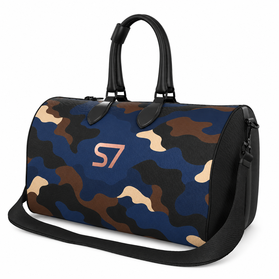 S7 Midnight Terrain leather duffle bag with midnight-blue, navy, beige, brown and black camouflage, a centered rose-gold S7 monogram and black trim.