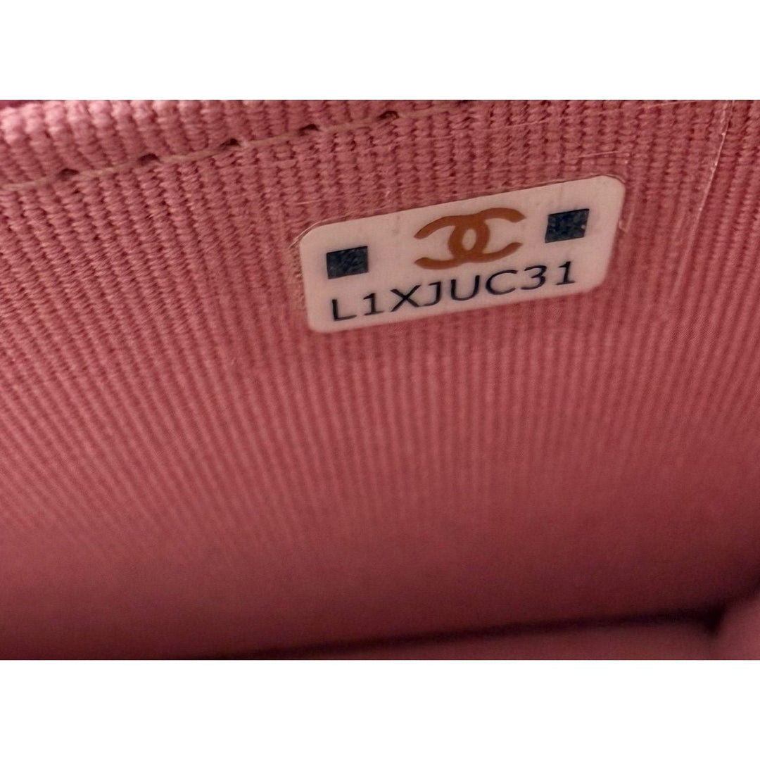 Close-up of a pink fabric surface with a Chanel label.