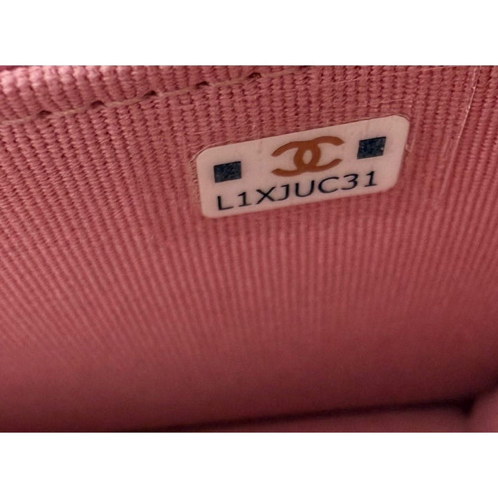 Close-up of a pink fabric surface with a Chanel label.