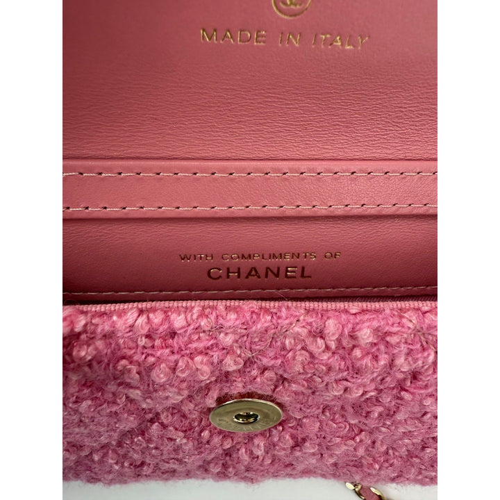 Close-up of a pink Chanel handbag with 'Made in Italy' and 'Chanel' branding.