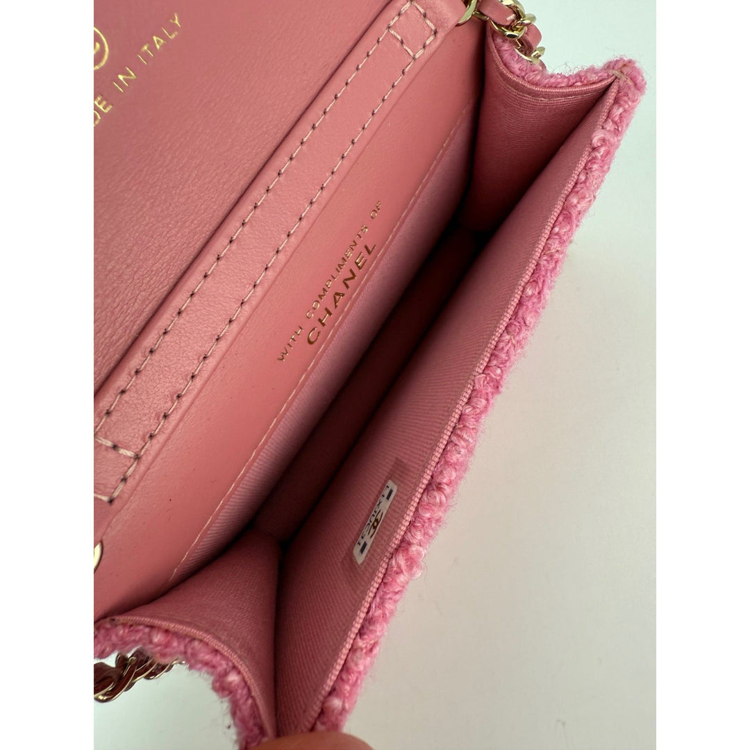 Close-up of a pink Chanel handbag with visible branding.