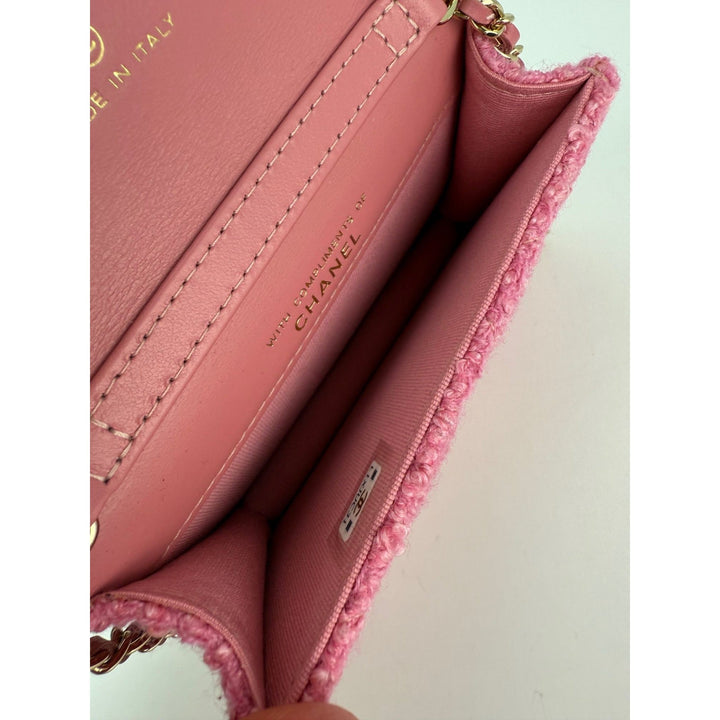 Close-up of a pink Chanel handbag with visible branding.
