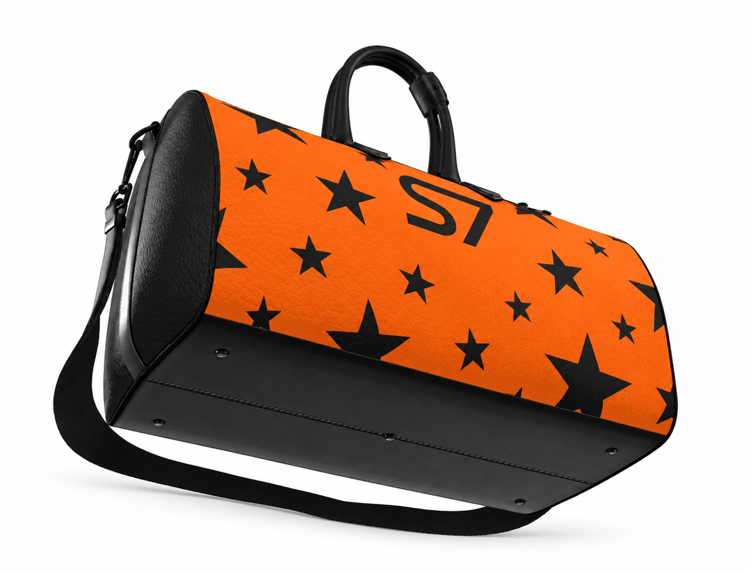 S7 Solar Noir orange leather duffle bag with scattered black five-point stars, a centered black S7 monogram and black handles and end panels.