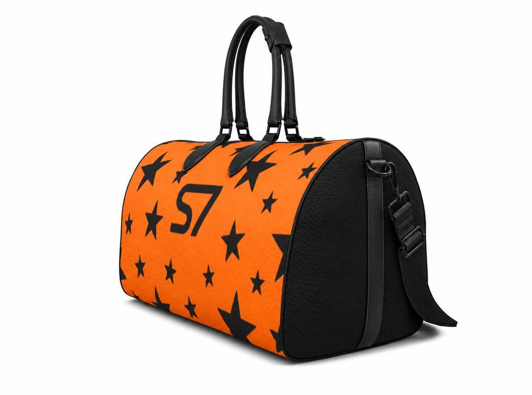 S7 Solar Noir orange leather duffle bag with scattered black five-point stars, a centered black S7 monogram and black handles and end panels.