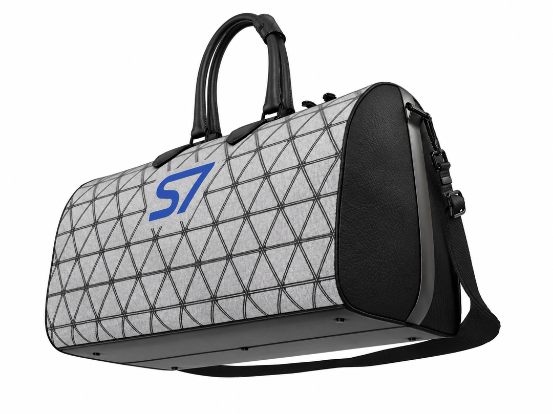 S7 PRISM duffle bag featuring black triangular lattice on a heather-gray background with a single cobalt-blue S7 logo.