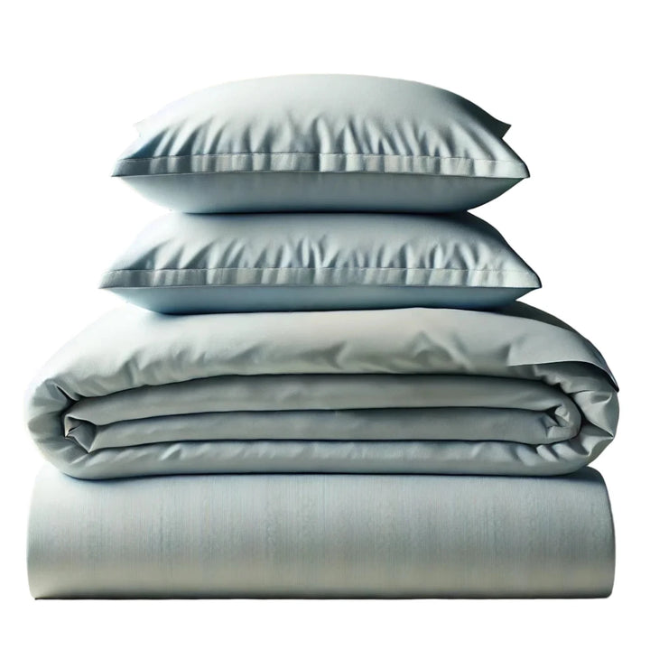 Stack of light gray bedding including a duvet, two pillows, and a flat sheet on a white background.