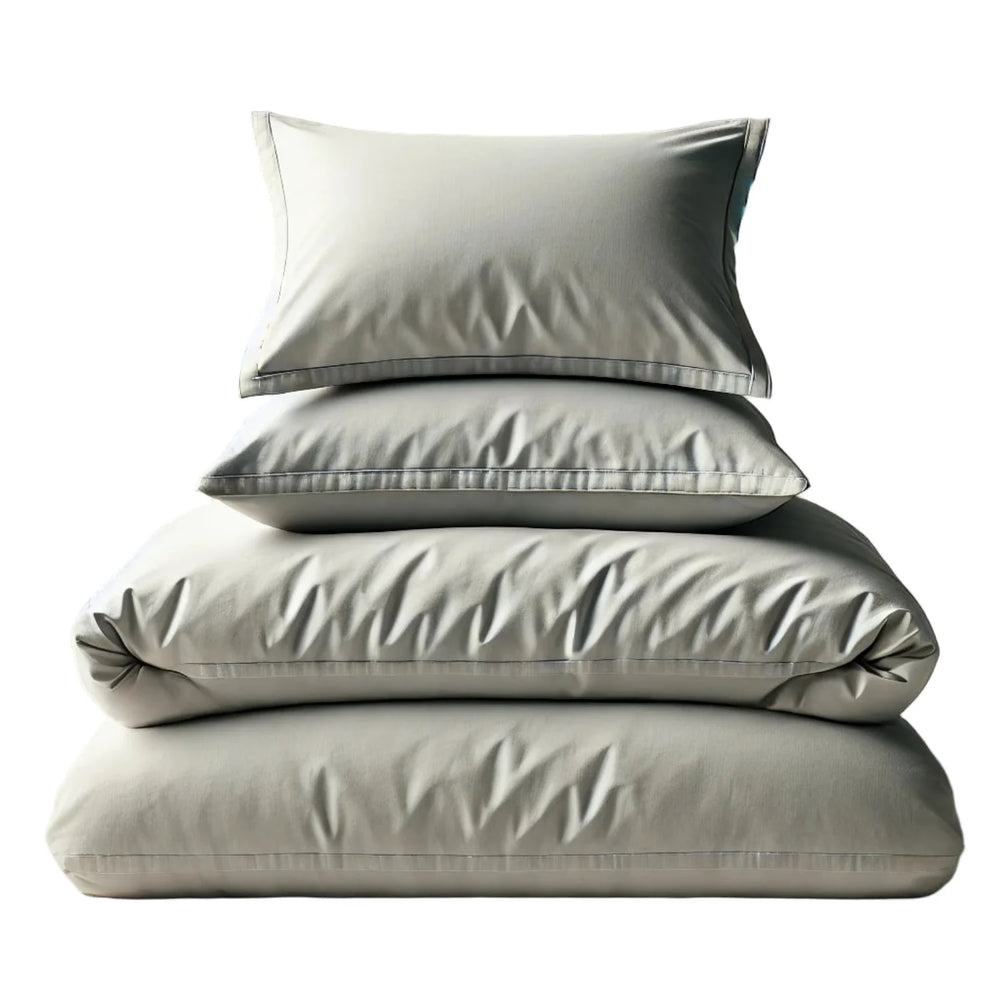 Stack of light gray bedding including a duvet, two pillows on a white background