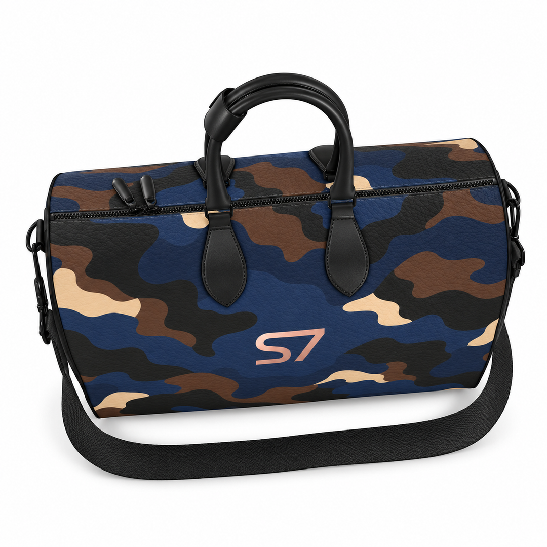 S7 Midnight Terrain leather duffle bag with midnight-blue, navy, beige, brown and black camouflage, a centered rose-gold S7 monogram and black trim.