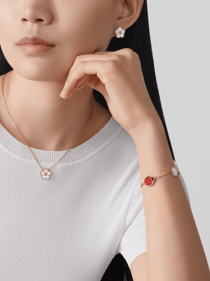 Van Cleef & Arpels Lucky Spring pendant, plum blossom 18K rose gold, Mother-of-pearl worn with matching earrings.