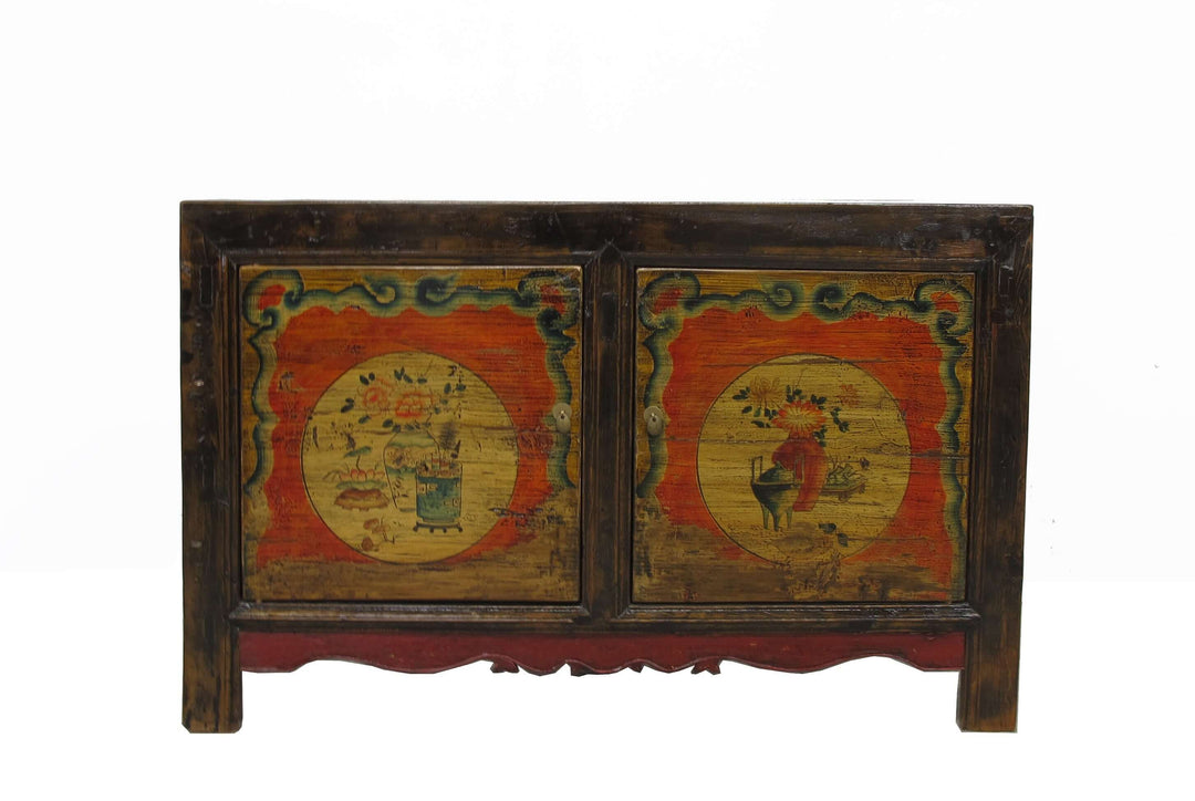 Vintage wooden cabinet with painted designs on a white background