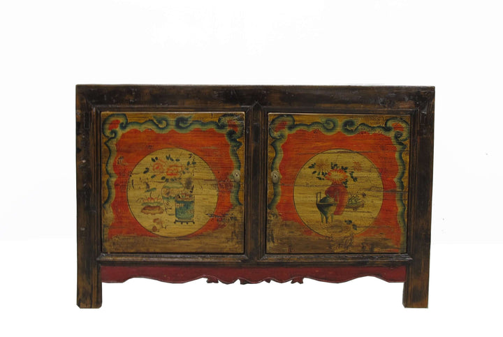 Vintage wooden cabinet with painted designs on a white background