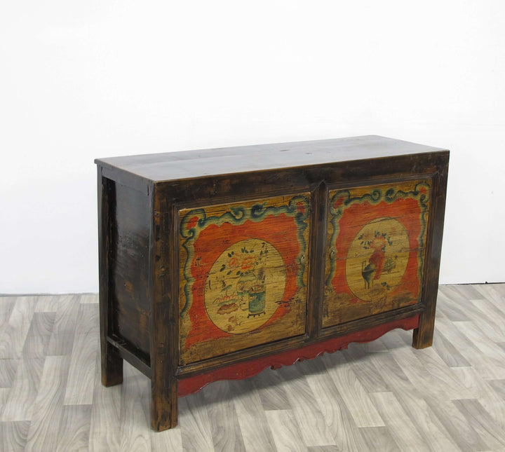 Wooden cabinet with decorative paint on a wooden floor