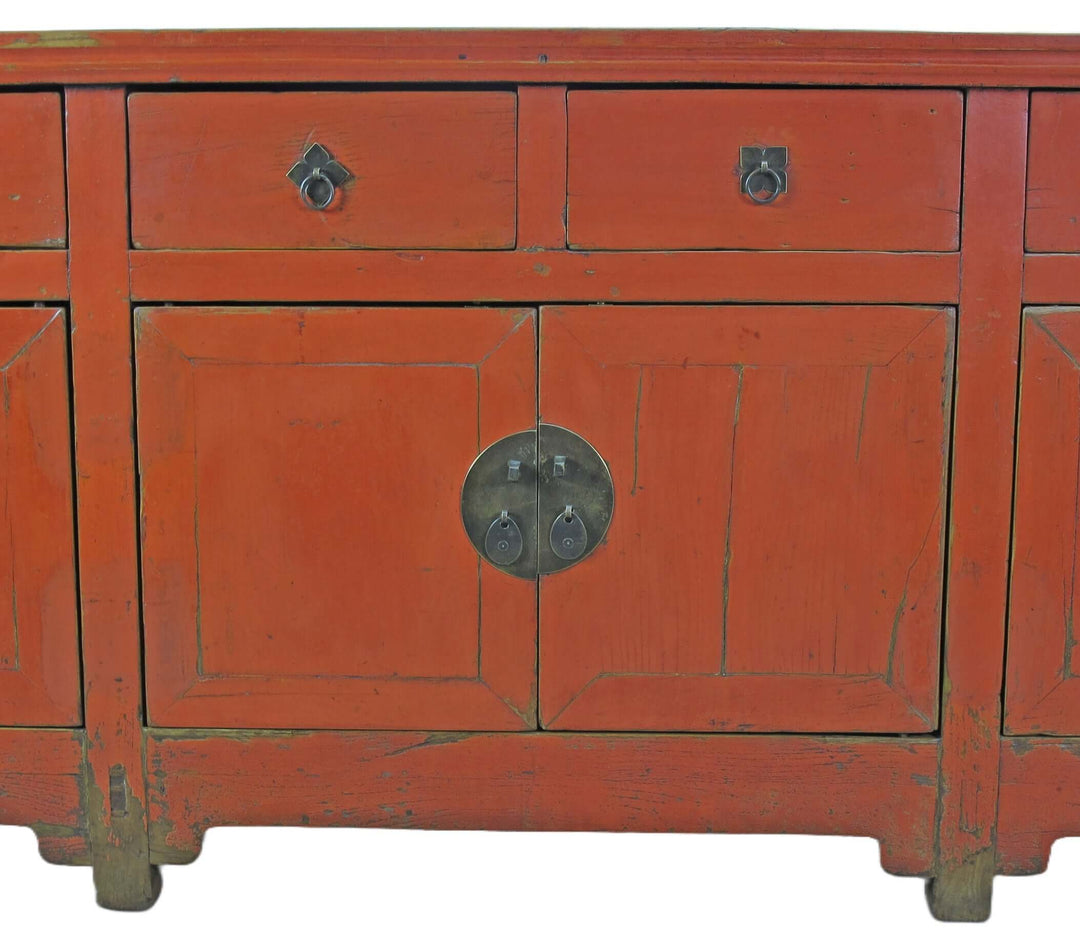 Red wooden cabinet with a circular handle on a white background