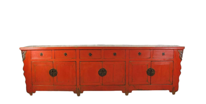 Red wooden sideboard with decorative elements on a white background