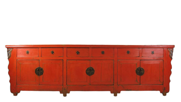 Red wooden sideboard with circular handles on a white background
