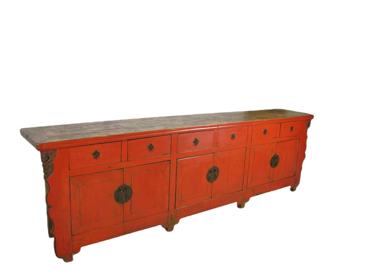 Red wooden sideboard with a gray top on a white background