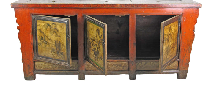 Vintage wooden cabinet with red paint and decorative doors on a white background