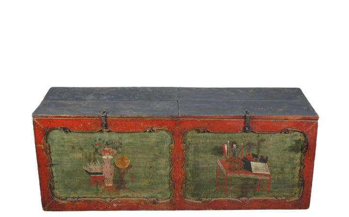 Vintage wooden trunk with red and green paint on a white background