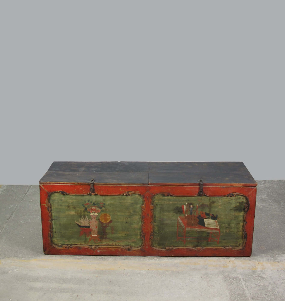 Vintage wooden trunk with painted designs on a gray background